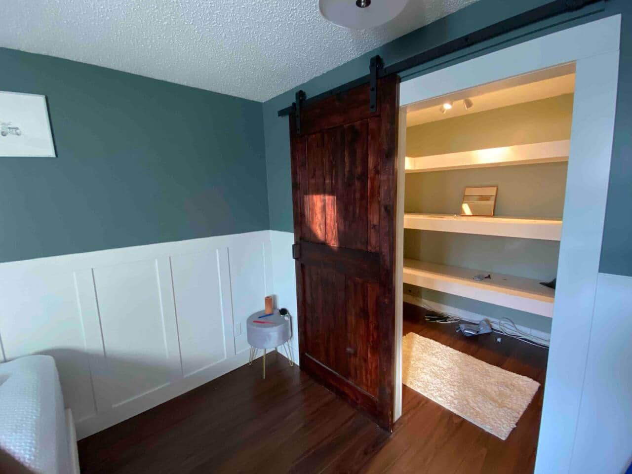 Barn-style sliding door open to closet shelves