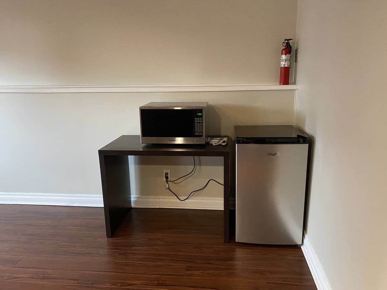 Kitchenette with a microwave and compact refrigerator